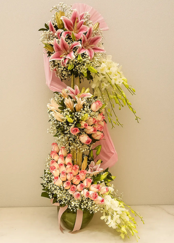 Floral arrangement with pink and white flowers on a plain background