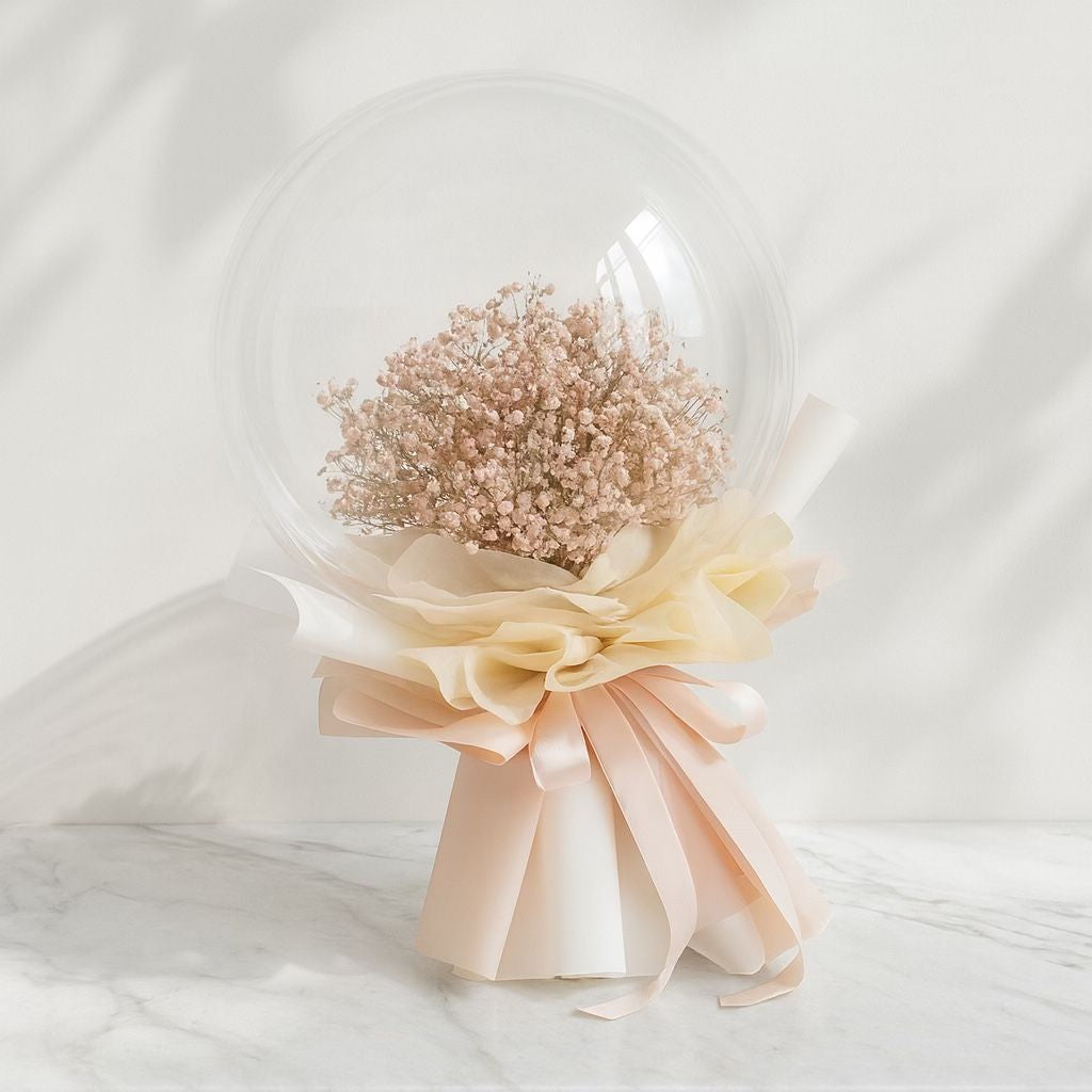 Bouquet of flowers in a clear dome with a beige ribbon on a white background