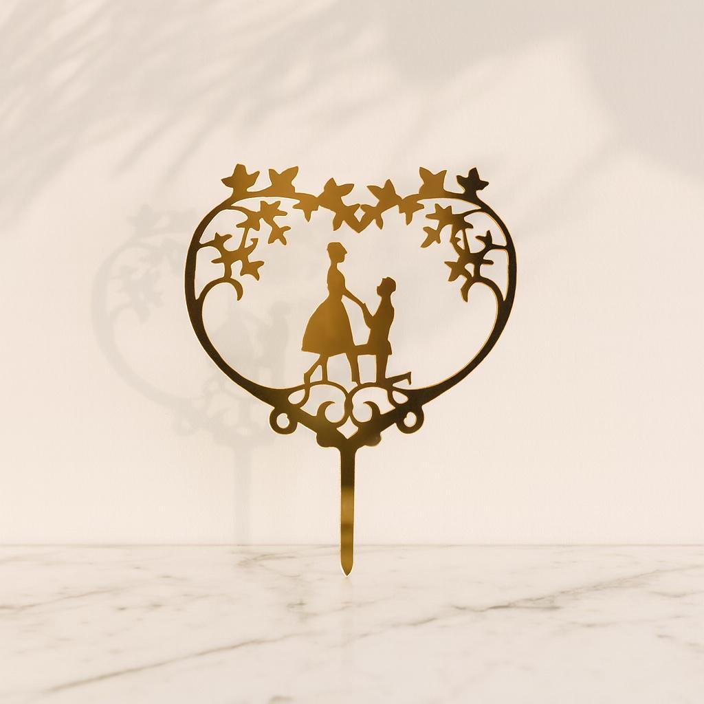 Decorative cake topper with a heart design and couple silhouette on a marble background